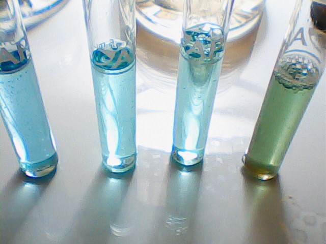 high angle view of four different pH water test results
