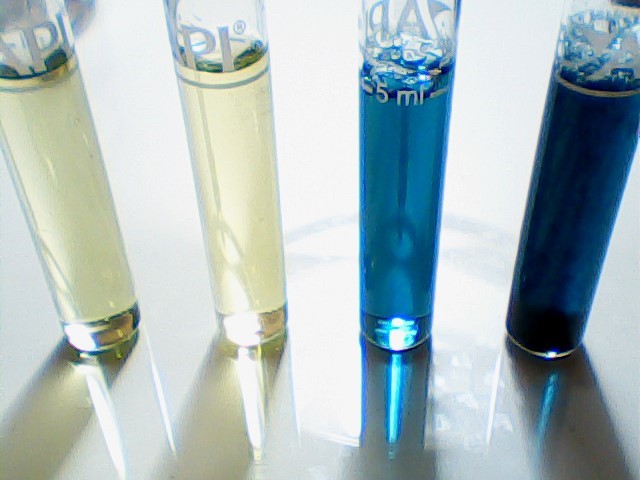 high angle view of four different pH water test results